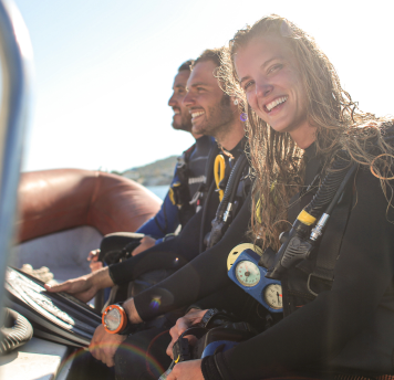 three scuba divers smiling and preparing for discover scuba session at the scuba club tucson