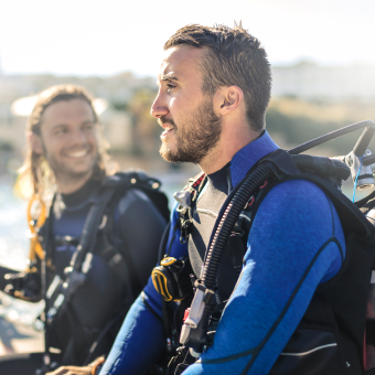 two scuba divers smiling and preparing for dive session at the scuba club tucson