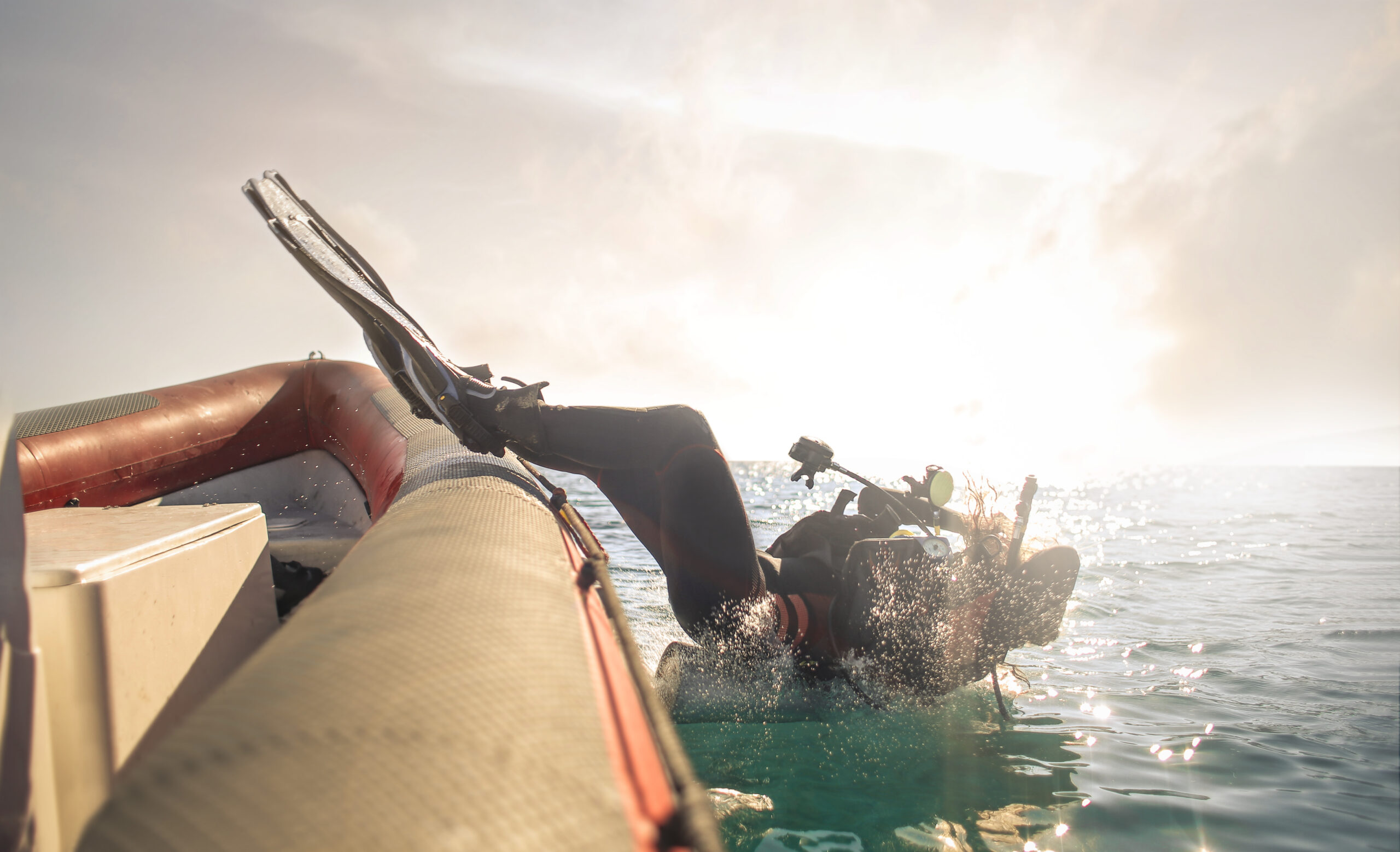 a woman diver dropping into the water on a trip arranged by the scuba club tucson